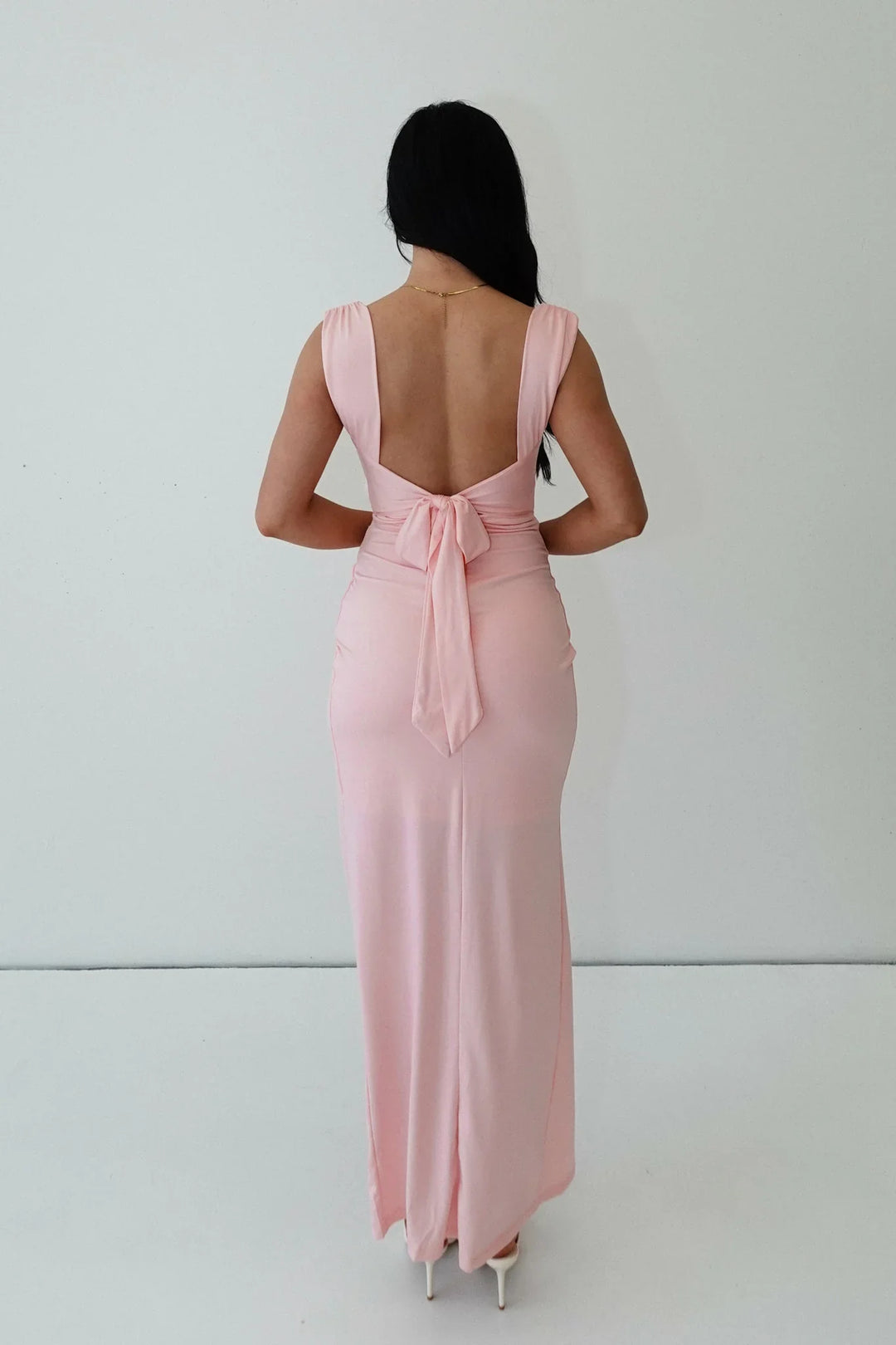 Pink tight-fitting dress with a slit and ruching