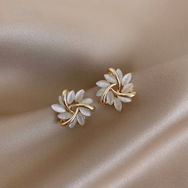 Gold earrings with opal flower designs