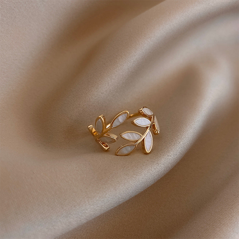 Adjustable gold ring with leaf and white opal